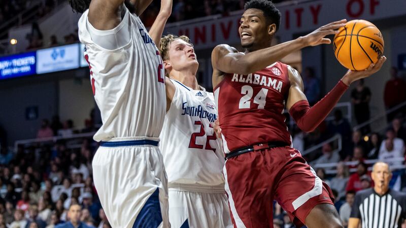 Alabama forward Brandon Miller (24) works against South Alabama center Kevin Samuel (21) and...