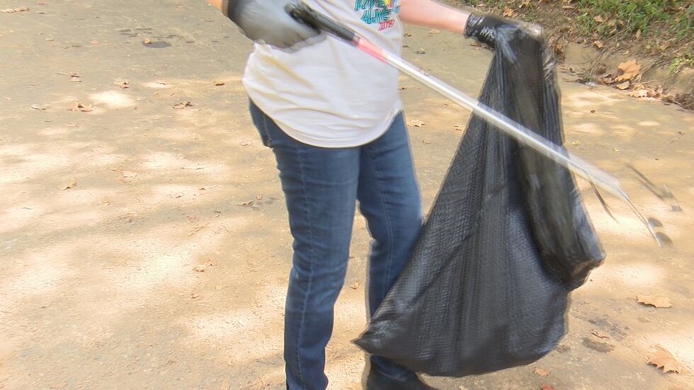 Volunteers picking up trash along the Flint River.
