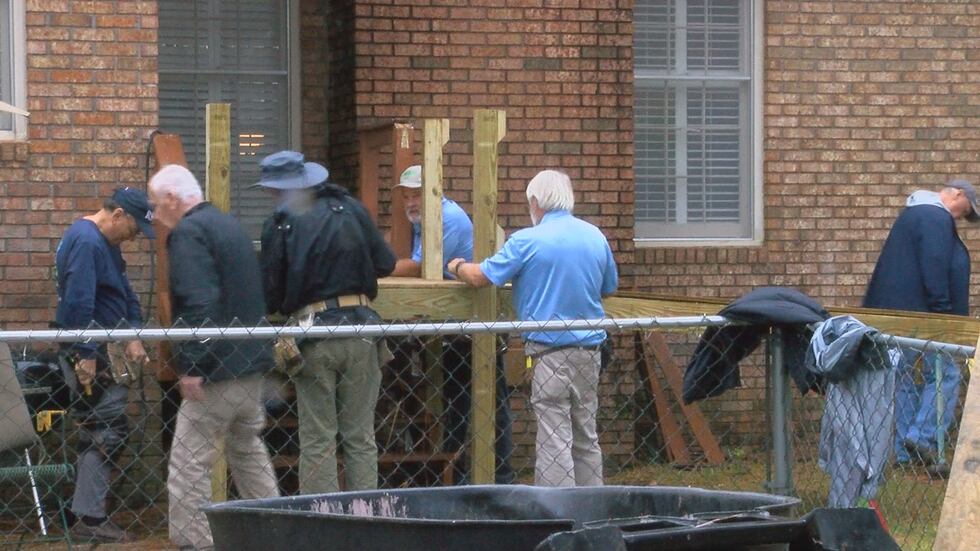 Veterans at work building the wheelchair ramp.