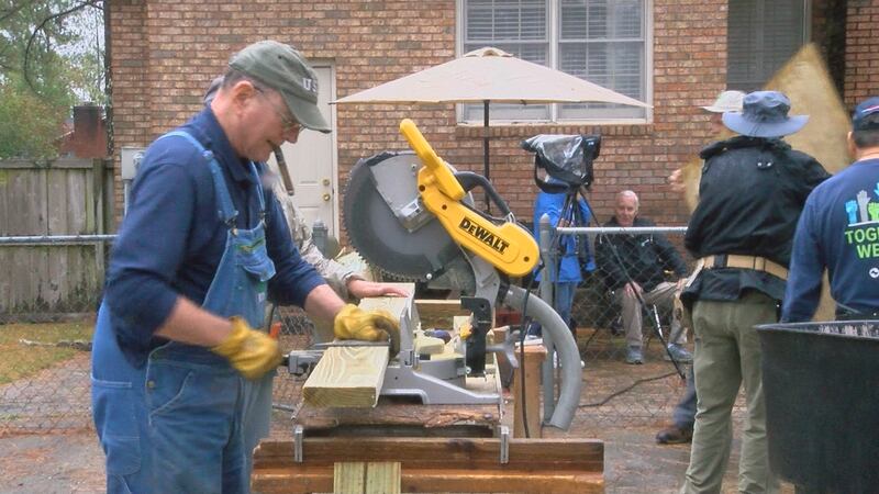 Workers working on the wheelchair ramp.