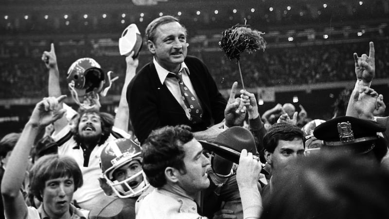 FILE - Georgia football coach Vince Dooley is carried off the field after Georgia defeated...