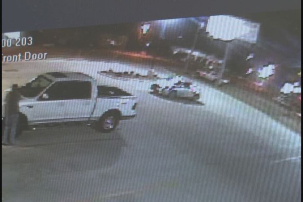 Surveillance image of the suspect's car (center, right), which police describe as a Gray or...