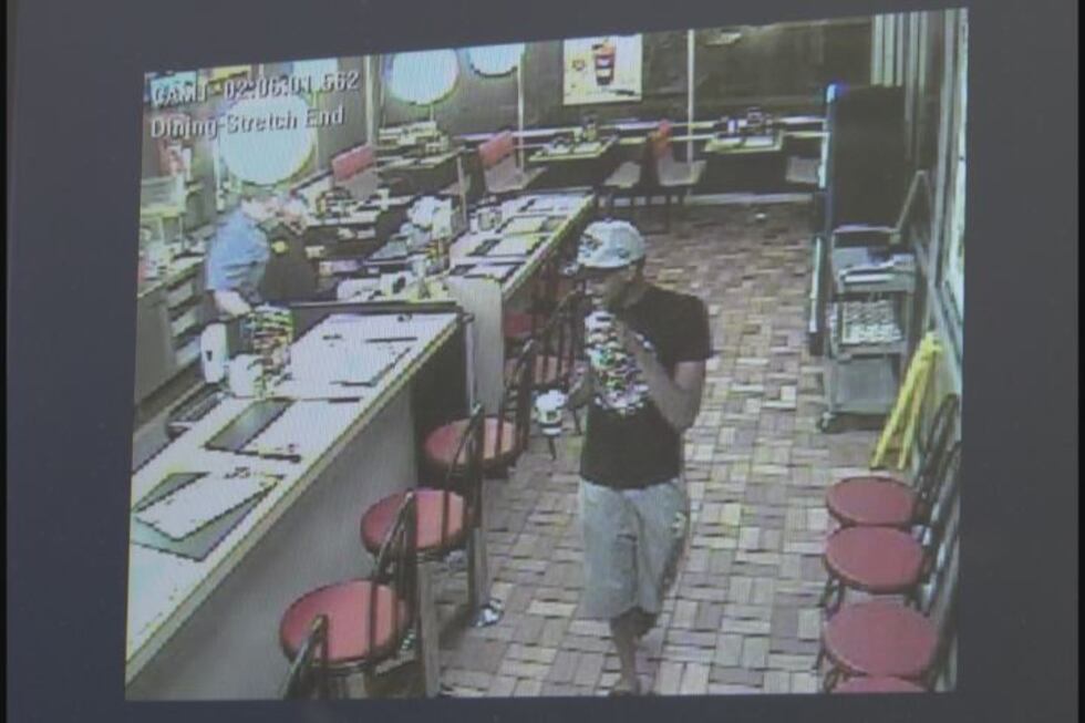 Surveillance image of the suspect leaving the Waffle House after loading his debit card with...