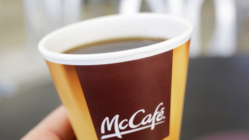 FILE - In this Thursday, Feb. 14, 2013 file photo, coffee served in a foam cup is held for a...