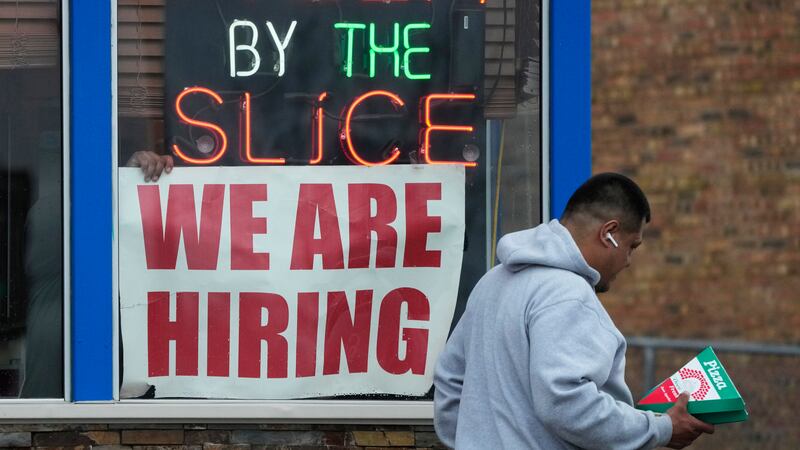 A hiring sign is displayed at a restaurant in Prospect Heights, Ill., Tuesday, April 4, 2023....