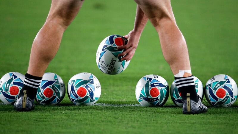 Rugby balls are lined up o the field by a New Zealand player ahead of the Rugby World Cup Pool...